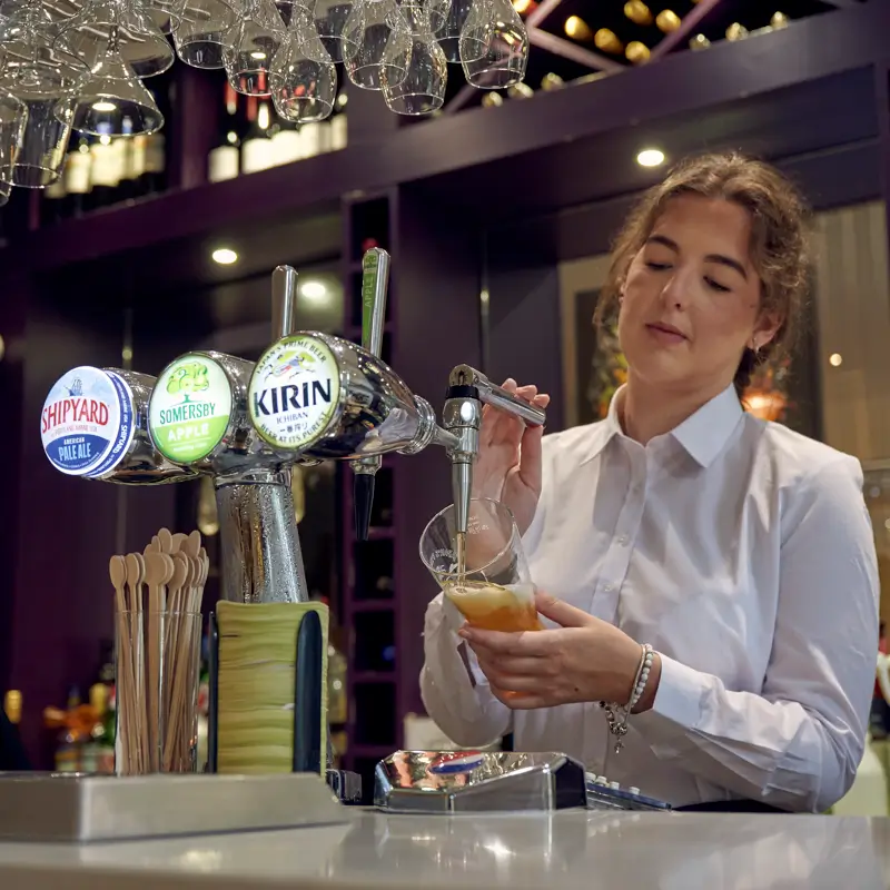 Bar staff pouring a pint