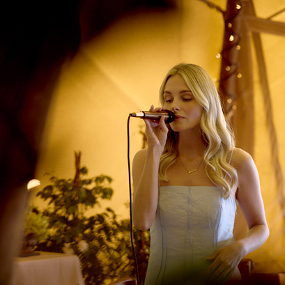 Danielle singing in the tipis