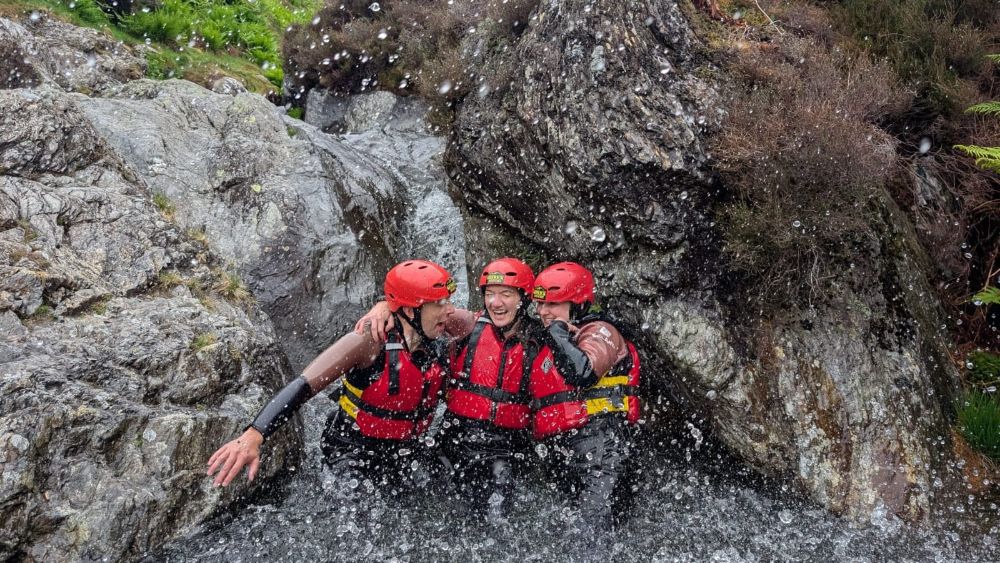 Group of laughing women being splashed in a Lake District ghyll