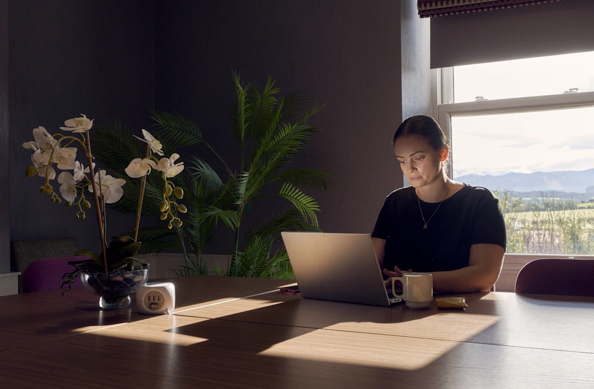 Woman working at a laptop in a meeting room