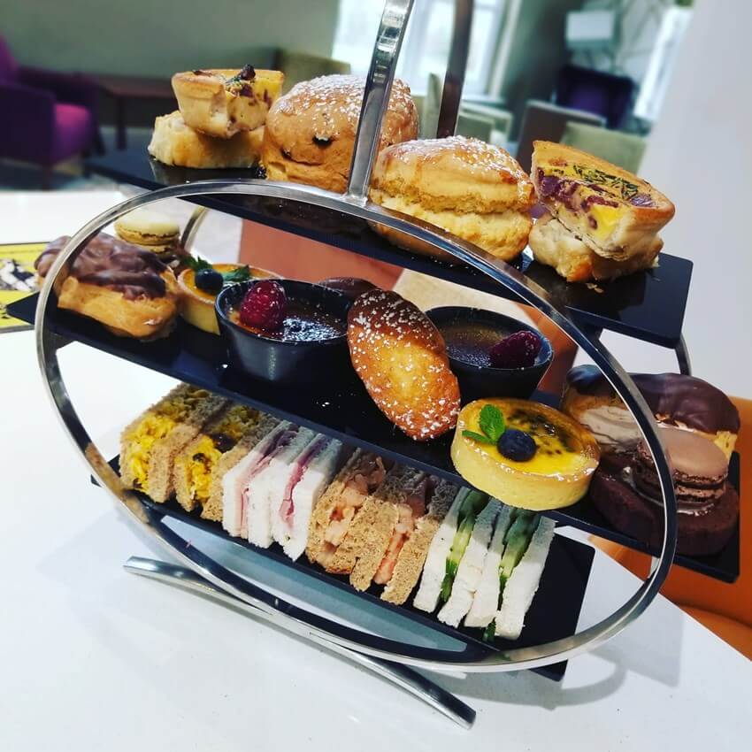 Afternoon tea platter with sandwiches, cakes and scones