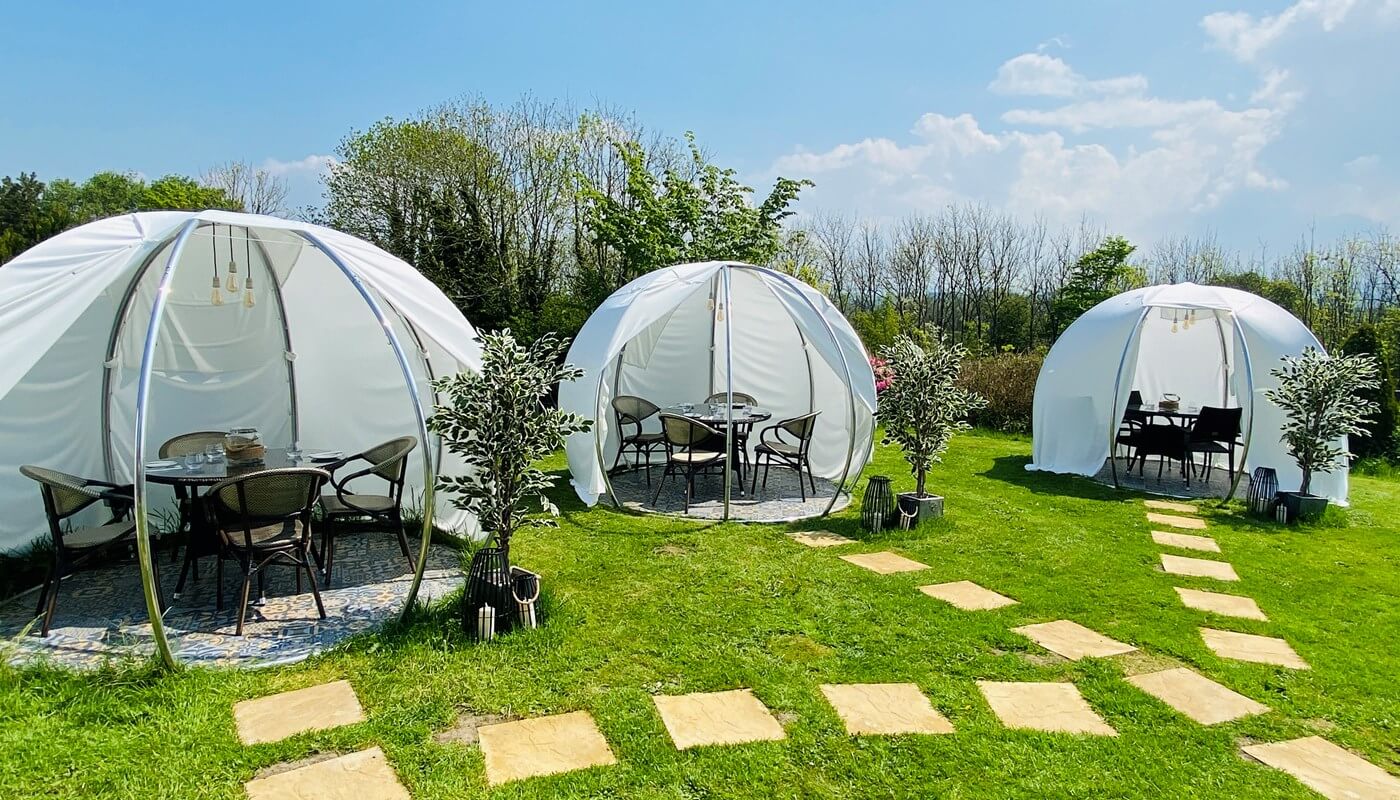 Outdoor dining pods at The Conservatory restaurant at The Melbreak Hotel