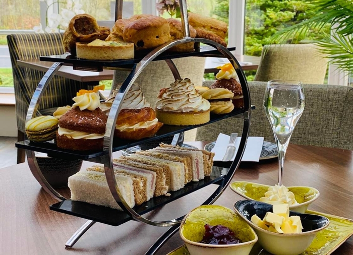 Platter for afternoon tea, including finger sandwiches, pastries and cakes