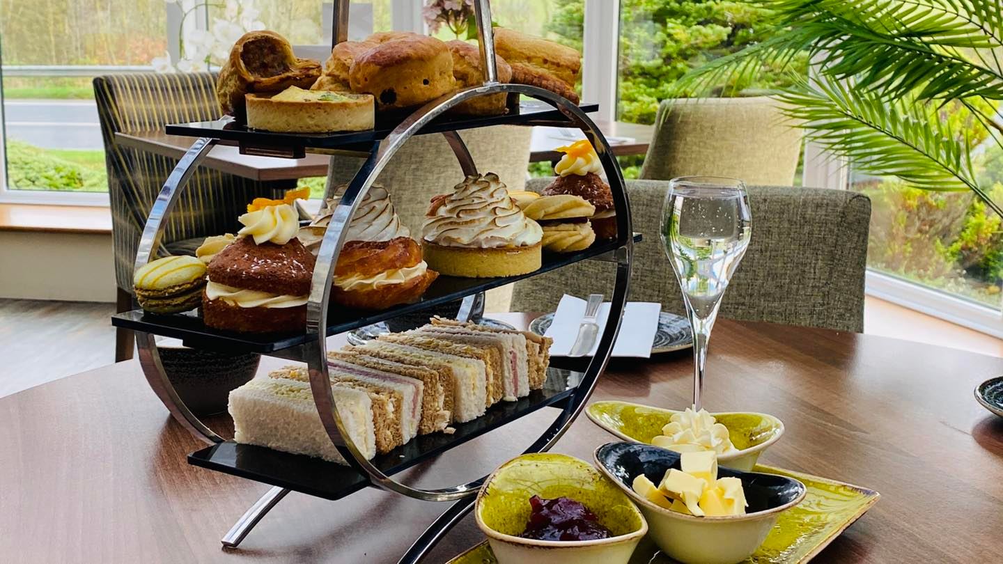 Platter for afternoon tea, including finger sandwiches, pastries and cakes